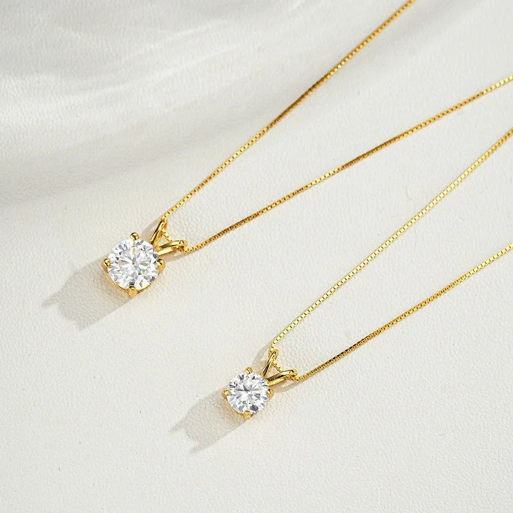Two gold necklaces with diamond pendants on a white background