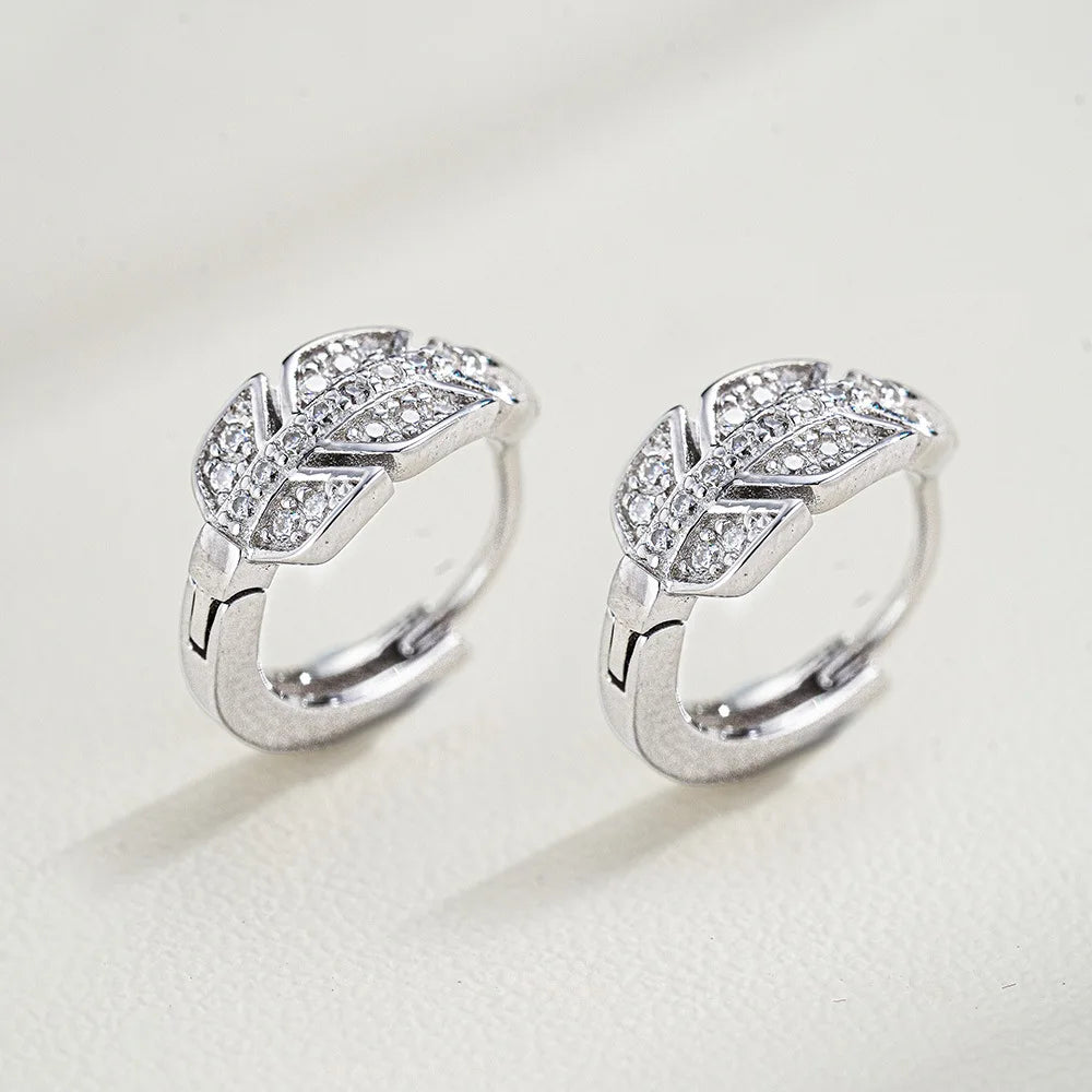 Pair of silver rings with diamond accents on a light gray background