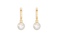 A pair of gold huggie hoop earrings with a single round white pearl drop on each earring, shown against a plain white background.