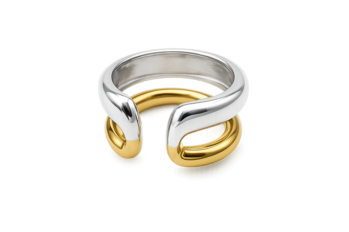 A two-tone metal cuff ring featuring a polished silver outer band and a gold inner band, shown on a clean white background.