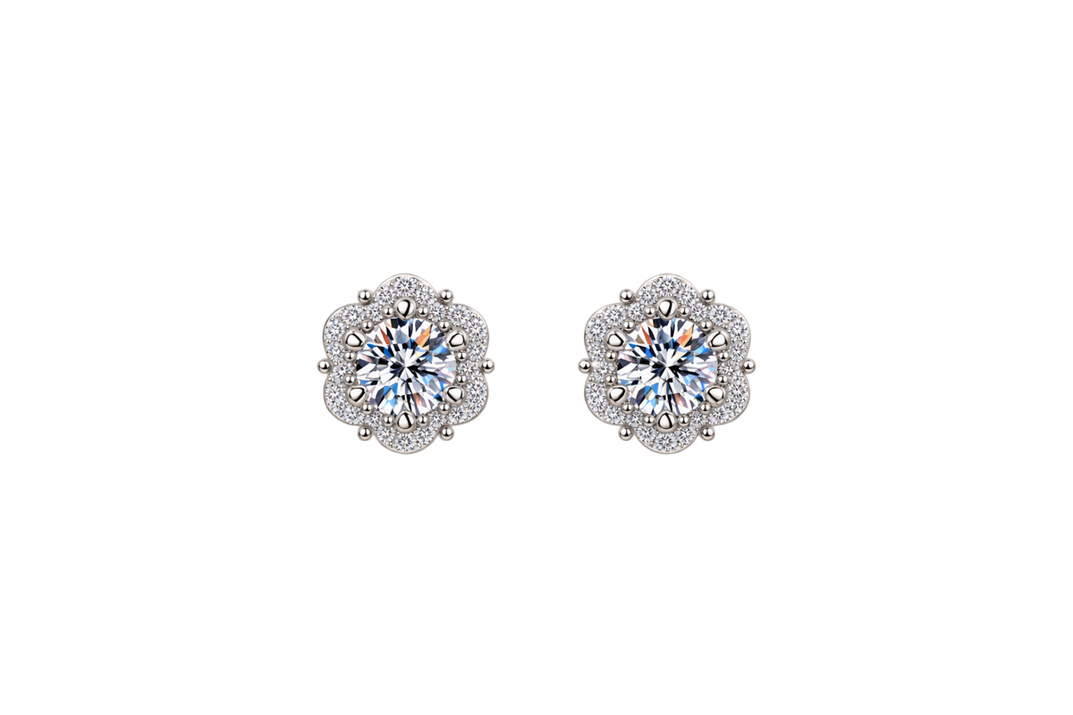 A pair of silver-toned stud earrings with round-cut iridescent center stones surrounded by small clear stones in a floral halo setting, shown on a plain white background.